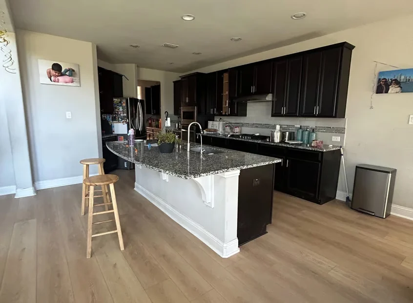 Kitchen and living space with continuous finished flooring